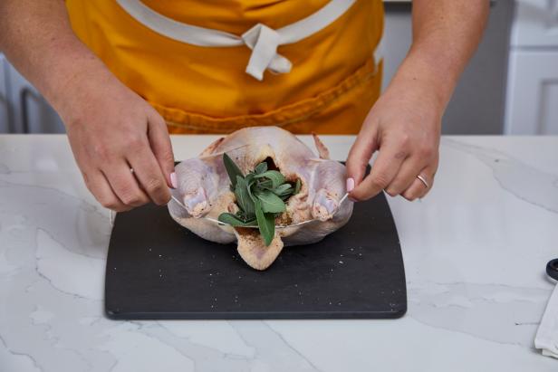 Season the chicken cavity and stuff it based on the recipe you're using.