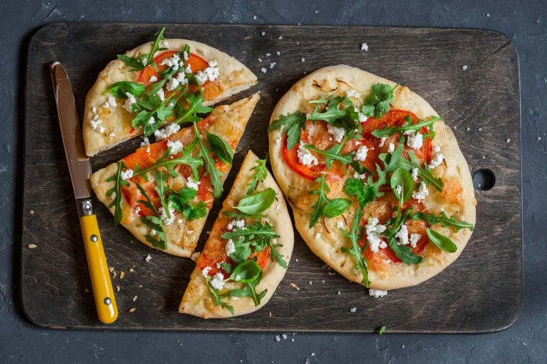 Brittany Poulson, MDA, RDN of <a target="_blank" href="https://www.yourchoicenutrition.com/">Your Choice Nutrition</a> and author of The Healthy Family Cookbook says “one of my go-to favorite lunches I've been eating when I'm working from home has been a whole wheat naan bread sprinkled with mozzarella cheese, topped with sliced tomatoes and basil (I prefer to use fresh if I have it, but dried works great too).” Poulson broils the pizza for a few minutes in the oven and enjoys it for lunch. “Essentially, it's a margherita pizza on naan,” she exclaims. “I love it because it's quick, easy, nutritious and fills me up.”