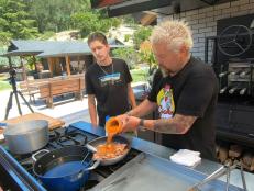 Host Guy Fieri and his Son Hunter Fieri Making a Sent Dish in the outdoor kitchen at Guy's House in Santa Rosa, California, as seen on Diners, Drive-Ins and Dives: Take Out, season 32.
