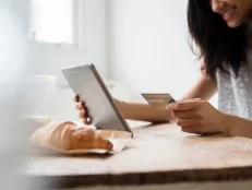 Mixed Race woman online shopping with credit card