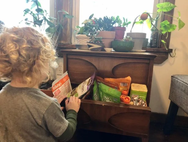 kid looking in snack drawer