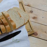 Loaf of sliced bread on a chopping board, high angle view