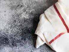 Kitchen towel or napkin over the rustic stone table. View from above with copy space