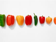 Line of Bell Peppers on white background, large to small.

Peppers arranged neatly.