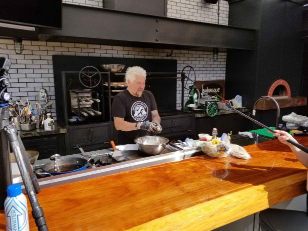 Behind-The-Scenes with Host Guy Fieri Making a Sent Dish in the outdoor kitchen at Guy's House in Santa Rosa, California as seen on Food Network's Diners, Drive-Ins and Dives: Take Out episode DV3204H.