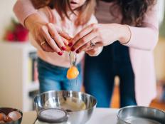 Mother learning her daughter to cook