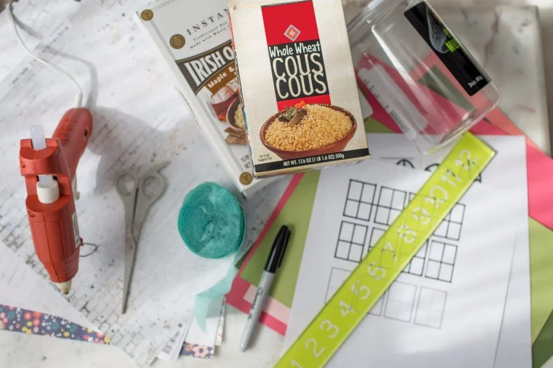 Empty food boxes/containers
Packing or masking tape
Scrapbook or construction paper
Scissors
Hot glue
Ruler
Glue stick
Streamers
Optional: Faux trees, plants, and moss 