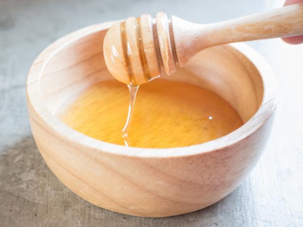 Golden honey cup and dipper, stock photo