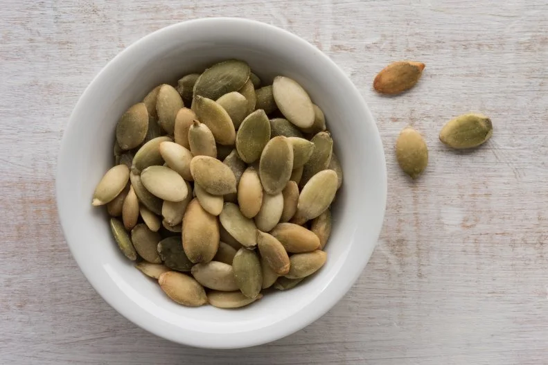 “Pumpkin seeds create an easy and nutritious snack, but also add essential nutrients and protein to on-the-road dishes,” says Kathy Siegel, MS, RDN, CDN nutrition consultant at <a target="_blank" href="https://triadtowellness.com/">Triad To Wellness</a> and author of <a target="_blank" href="https://www.amazon.com/30-Minute-Clean-Eating-Cookbook/dp/1646118863/ref=sr_1_1?dchild=1&keywords=the+30+minute+clean+eating+cookbook+and+kathy+siegel&qid=1596575407&sr=8-1">The 30 Minute Clean Eating Cookbook</a>. Siegel explains that pumpkin seeds are packed with zinc, iron, and magnesium, key minerals to strengthen immunity, and are a good source of plant-based protein with 8 grams of protein per ounce. “Enjoy pumpkin seeds on their own, mix them into trail mix, or toss them on salads, wraps, yogurt, and oatmeal.” 