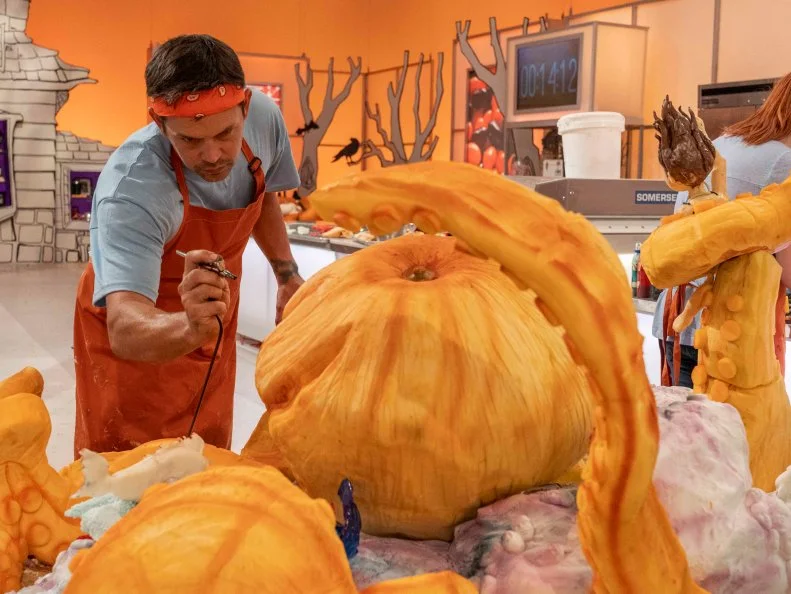 Team Candy Coroners Pumpkin Carver Chad Gaine at work during Episode 4 Spine Chiller challenge "Trapped with a monster", as seen on Halloween Wars, Season 10.