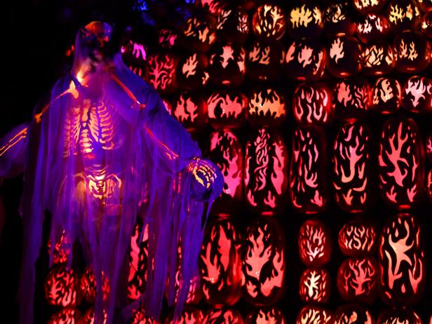 Illuminated pumpkins are on display during the Great Jack O'Lantern Blaze at Van Cortlandt Manor in Croton-on-Hudson, New York, on October 14, 2017. The Great Jack O'Lantern Blaze is for 45 evenings, including Halloween night and features over 7,000 hand-carved, illuminated pumpkins set against the mysterious backdrop of Van Cortlandt Manors 18th-century buildings and riverside landscape. / AFP PHOTO / TIMOTHY A. CLARY        (Photo credit should read TIMOTHY A. CLARY/AFP via Getty Images)