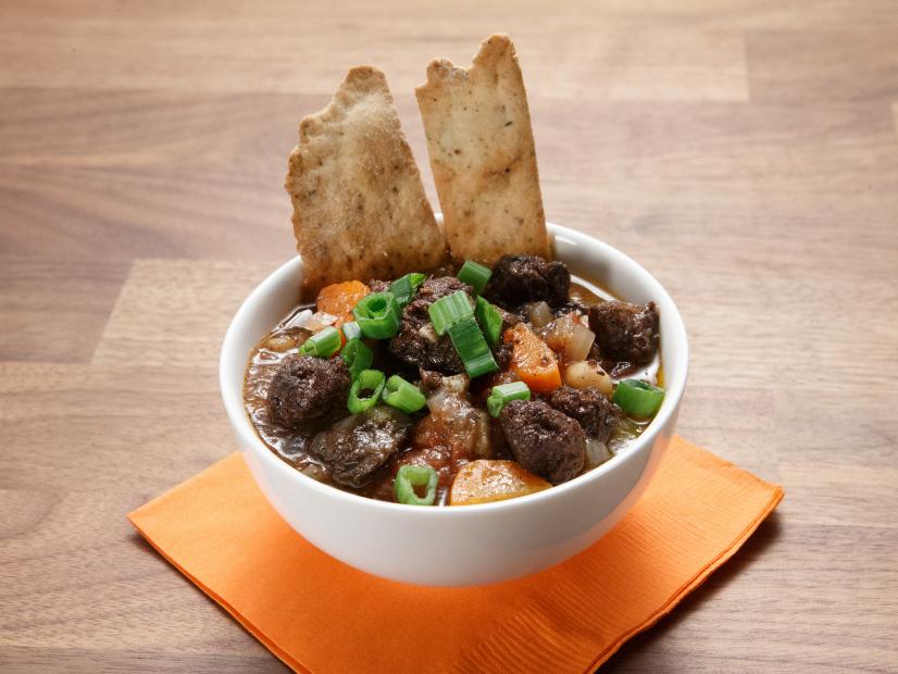 The blue team's Blood Sausage Stew with Tombstone Crackers is displayed, as seen on Worst Cooks in America Halloween Special.