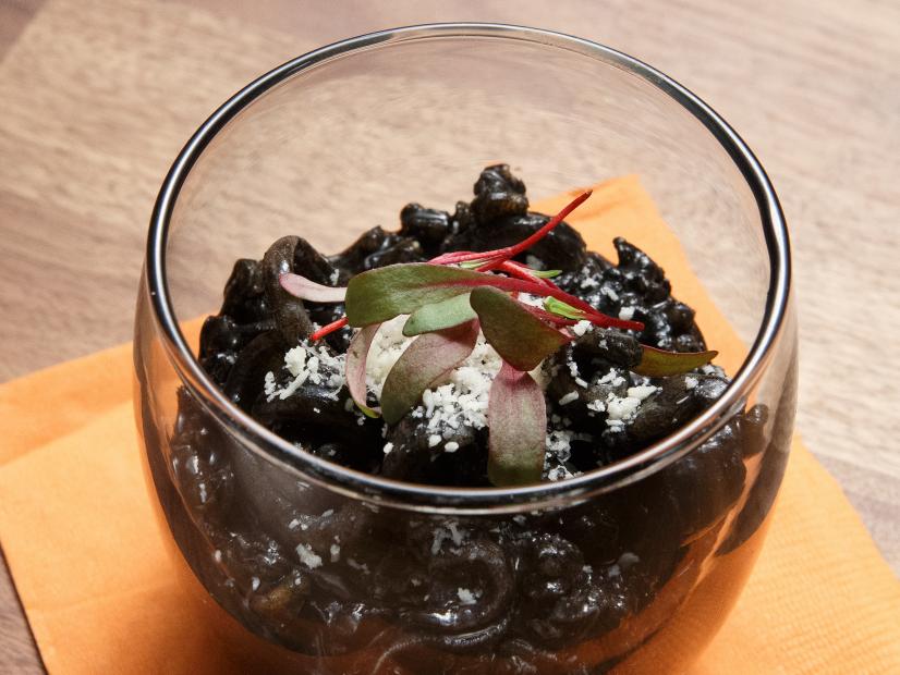 The red team's Squid Ink Risotto is displayed, as seen on Worst Cooks in America Halloween Special.