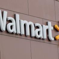 CHICAGO, IL - JANUARY 11:  A sign hangs outside Walmart store on January 11, 2018 in Chicago, Illinois. Walmart announced today it would use savings from the recently revised tax law to increase their starting wage to $11-per-hour, offer some hourly employees a one-time bonus up to $1000, expand maternity and parental leave benefits and will begin to offer adoption assistance. The company also disclosed today that it would be closing 63 of its Sam's Club stores across the US, costing thousands of workers their jobs.  (Photo by Scott Olson/Getty Images)