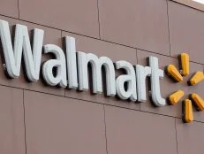 CHICAGO, IL - JANUARY 11:  A sign hangs outside Walmart store on January 11, 2018 in Chicago, Illinois. Walmart announced today it would use savings from the recently revised tax law to increase their starting wage to $11-per-hour, offer some hourly employees a one-time bonus up to $1000, expand maternity and parental leave benefits and will begin to offer adoption assistance. The company also disclosed today that it would be closing 63 of its Sam's Club stores across the US, costing thousands of workers their jobs.  (Photo by Scott Olson/Getty Images)