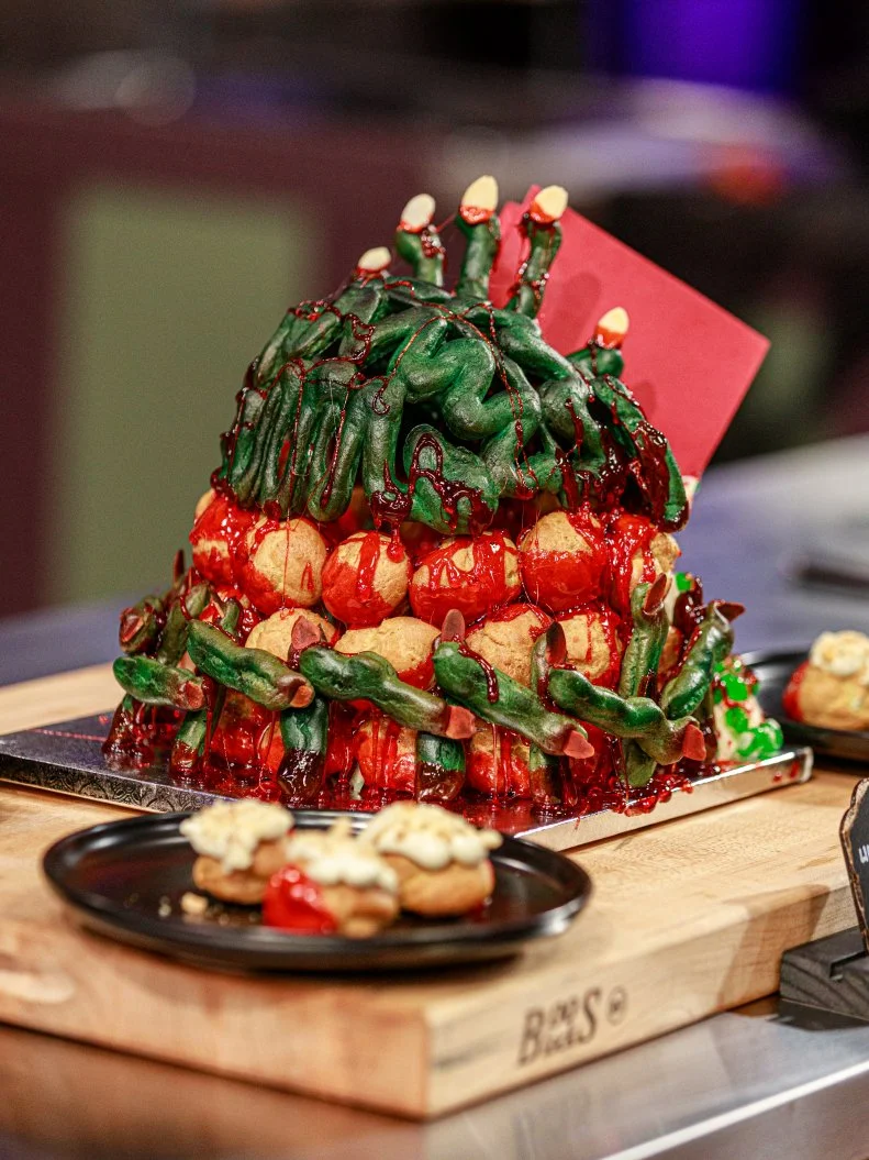Contestant Aaron Clouse LIME CANDY/ZOMBIES .PATE A CHOUX W/ KEY LIME FILLING, COVERED IN PUMPKIN MARSHMALLOW, PATE A CHOUX ZOMBIE FINGERS FENCE, as seen on Halloween Baking Championship, Season 6.