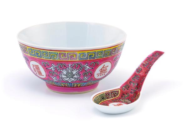 Traditional mass produced chinese rice bowl or soup bowl with spoon on white background