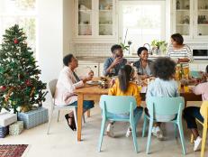 Family and friends talking while enjoying meal at home during Christmas festival