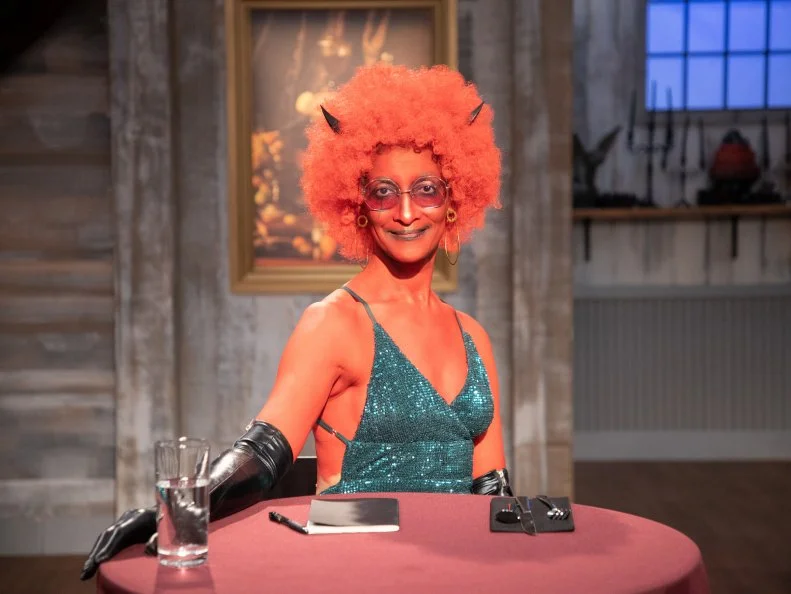 Carla in costume at judges table looking to camera, as seen on Halloween Baking Championship, Season 6.