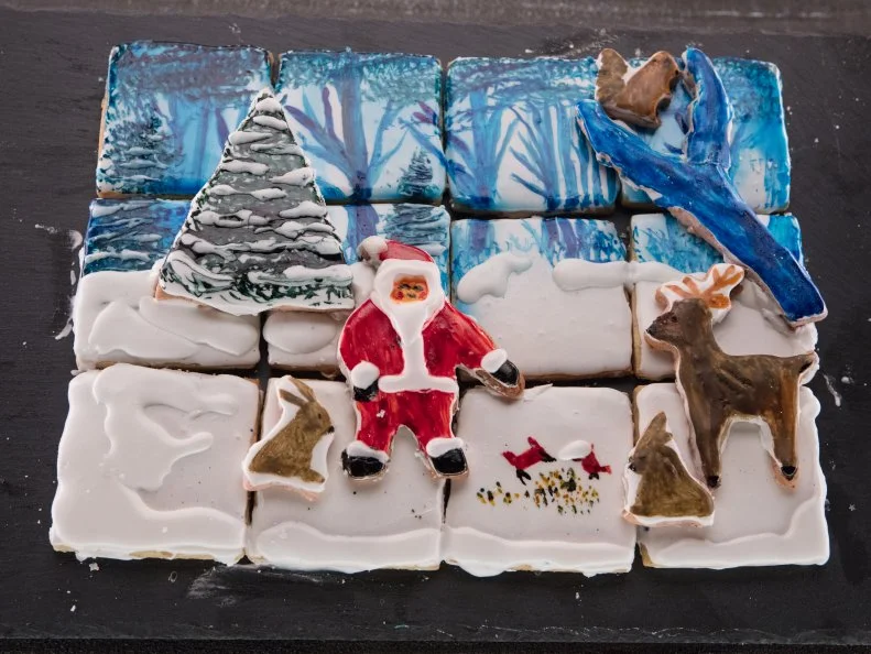 Contestant Stephen Horner's Winder Wonderland Cookie with sage brown butter and orange zest cookie with vanilla royal icing and freeze dried cherry and Kirsh sugar cookie with vanilla royal icing, as seen on Christmas Cookie Challenge, Season 3.