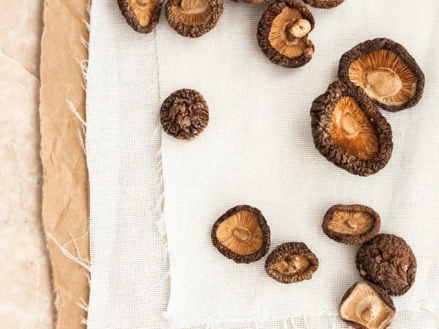 Dried shiitake mushrooms over table.