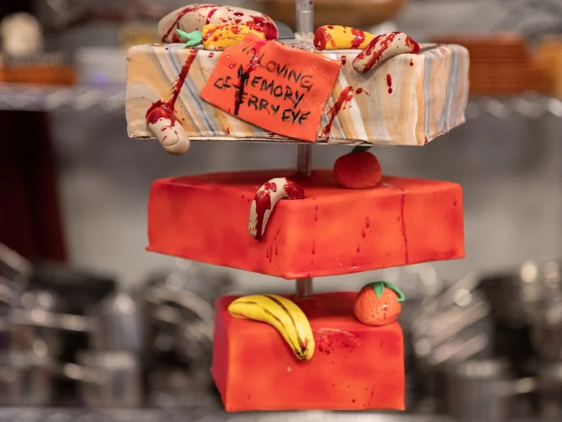 Sinai's cake - SPIRIT: TERRY FYE. .ORANGE VANILLA CAKE W/ DARK CHOCOLATE COCONUT GANCHE AND PASSIONFRUIT BUTTERCREAM. .TREAT TWIST: COCONUT. .TRICK TWIST: FONDANT IN MEMORIAM CARD, as seen on Halloween Baking Championship, Season 6.