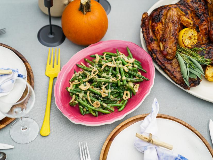 Outdoor table setting; overhead of Miso Butter Green Beans dish, as seen on Sunny Anderson Thanksgiving.