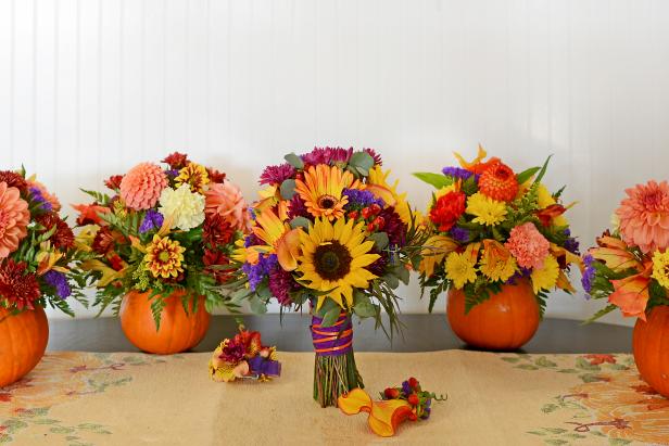 Photograph of an autumn bridal bouquet, boutonniere, and pumpkins used as vases and filled with fall flowers.