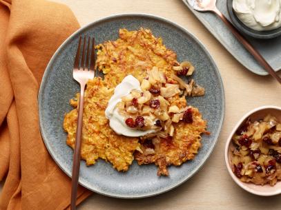 Food Network Kitchen’s Sweet Potato and Carrot Latkes with Spiced Apple-Cranberry Relish, as seen on Food Network.