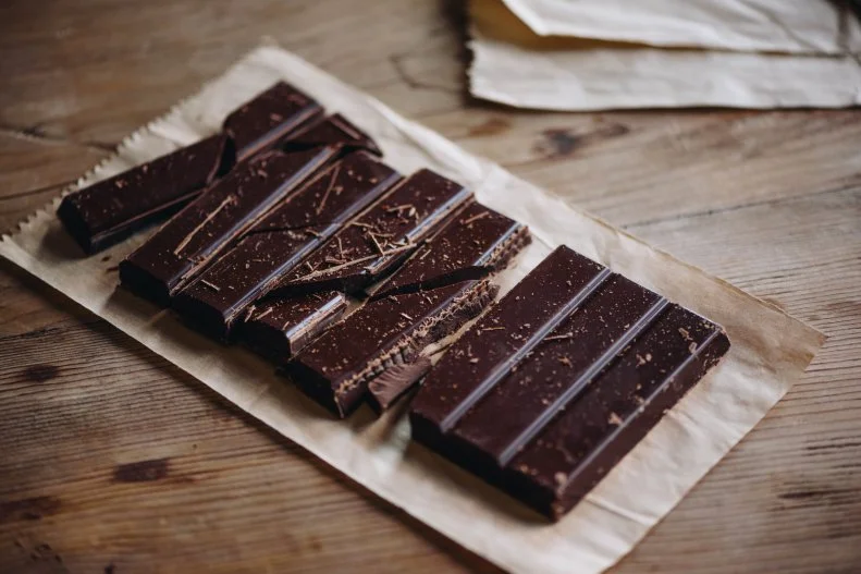 Cocoa beans provide numerous antioxidants, including theobromine, which has been shown to help reduce blood pressure. When purchasing dark chocolate look for at least 60% cacao to get more theobromine. Plus, because dark chocolate is calorie dense at 150 calories per ounce limit portions to 1 ounce maximum per day.