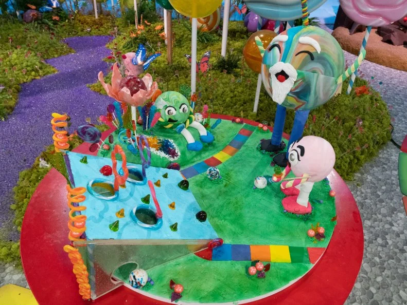 The cake titled Lolliputt created by red team contestants Deavynne Millward, Deva Williamson, Jewel Johnson and Ray Miranda-Vizcaino , as seen on Candyland, Season 1.