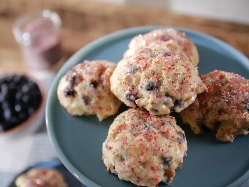 Beauty shot of Molly Yeh's Blueberry Cream Cheese Scones with Yogurt Glaze, as seen on Girl Meets Farm, season 7.