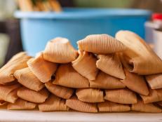 Delicious traditional Mexican tamales piled on a table