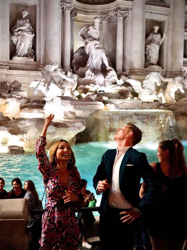 Giada De Laurentiis and Bobby Flay toss coins into the Trevi Fountain, as seen on Bobby & Giada in Italy, Season 1.