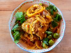 Chicken tagine is a classic Moroccan dish made in a special pot called a tagine and usually features preserved lemons and olives. This recipe uses lots of the warm spices and harissa that are authentic to Morocco, but it is cooked in a skillet. The substitution of fresh lemons makes this practical for a weeknight without a trip to the market or online.