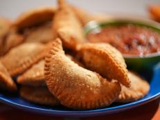 This is one of the first recipes I ever devised at Butter. I imagined that the meaty taste of the beef would come through more powerfully if boosted by tart cream cheese and heat from poblano chiles. The subtle addition of these two ingredients takes the filling to the next level. Make the empanadas the day before for best results. The longer these flavors get a chance to meld together, the tastier the result. Take care when cleaning the poblanos, they are deceptively spicy so wear gloves (or small plastic bags over your hands) when cleaning the ribs and seeds.