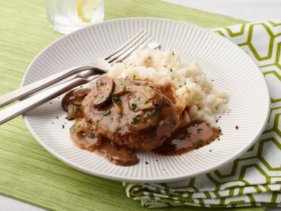Food Network Kitchen’s Hamburger Steaks with Onion and Mushroom Gravy, as seen on Food Network.
