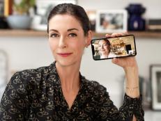 Close-up of Mary McCartney smiling and holding an iphone with Kate Hudson on camera