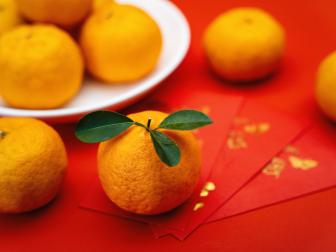 Mandarin Oranges and Red Envelope on Red Background. Chinese New Year.