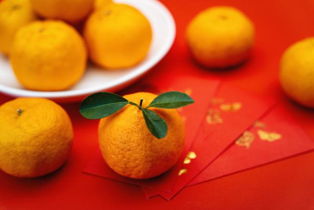 Mandarin Oranges and Red Envelope on Red Background. Chinese New Year.