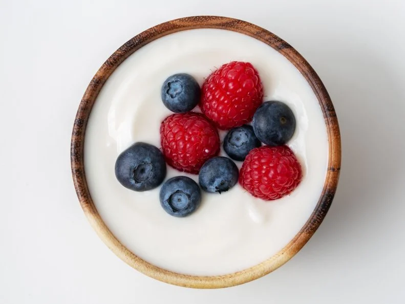 Berry yogurt in a bowl and fresh blueberry, raspberry