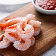 Close up of Shrimp Cocktail with Sauce in the Background.