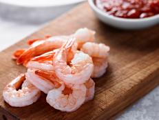 Close up of Shrimp Cocktail with Sauce in the Background.