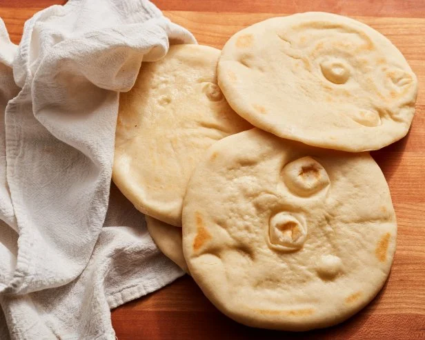 Description: Food Network Kitchen's Grilled Pita Bread. Keywords: Flour, Instant Yeast, Salt, Sugar, Olive Oil