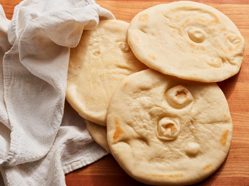 Description: Food Network Kitchen's Grilled Pita Bread. Keywords: Flour, Instant Yeast, Salt, Sugar, Olive Oil