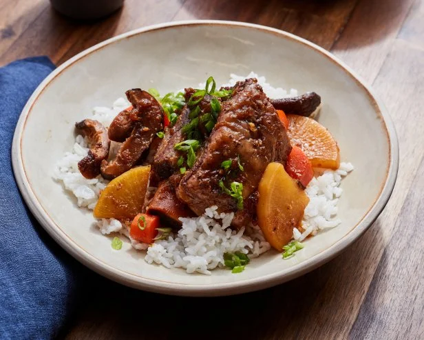 Description: Food Network Kitchen's Instant Pot Galbijjim. Keywords: Korean Pear, Onion, Garlic, Soy Sauce, Sugar, Corn Syrup, Mirin, Korean Radishes, Carrots, Shiitake Mushrooms, Sesame Oil, Scallions, White Rice