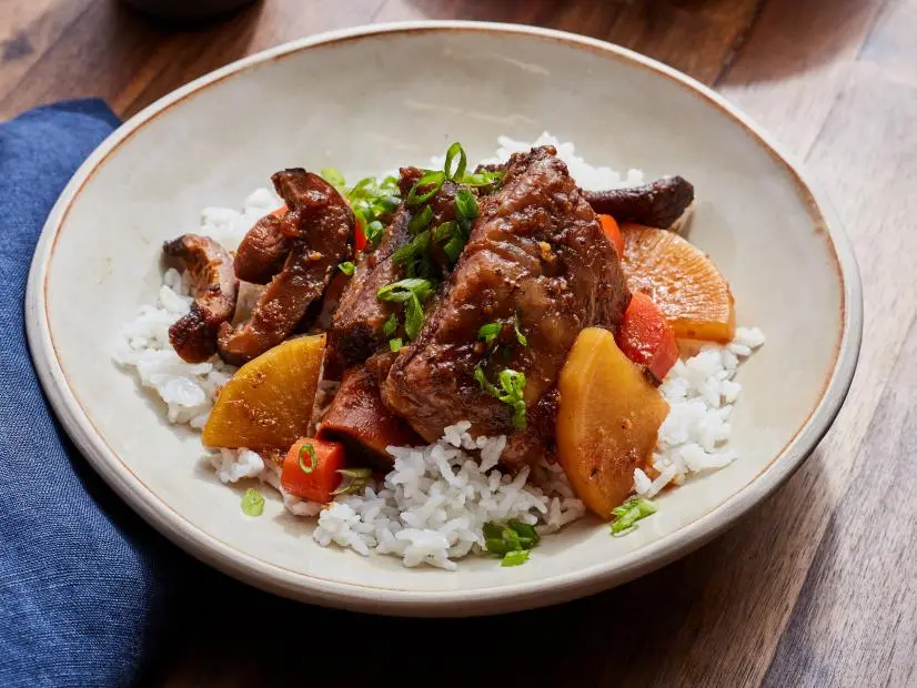 Description: Food Network Kitchen's Instant Pot Galbijjim. Keywords: Korean Pear, Onion, Garlic, Soy Sauce, Sugar, Corn Syrup, Mirin, Korean Radishes, Carrots, Shiitake Mushrooms, Sesame Oil, Scallions, White Rice