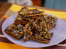 I love matzo. It's got great crunch and, while it's pleasantly bland, it is like a canvas for other flavors to work their magic. I also love the slightly toasted taste it naturally has. This bark has matzo as its foundation; the salted caramel and chocolate layers are bolstered by dried fruit and toasted seeds. The rainbow sprinkles are vibrant and fun. I love their texture against the nutty pumpkin seeds and pleasantly chewy apricots. They make me feel like a kid again. Store these in an airtight container at room temperature or in the fridge and enjoy for a couple of days. They won't be around longer than that anyway.