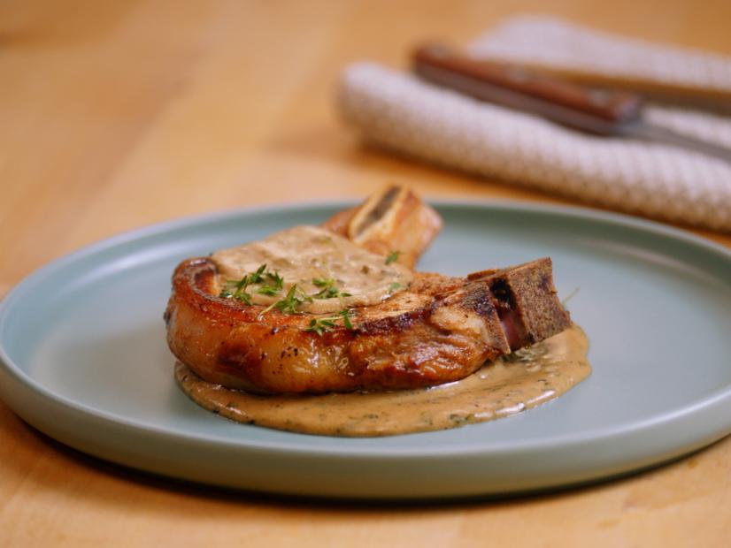 Close up of plated pork chop with sauce on plate ,as seen on Un-Choppable, Season 1.