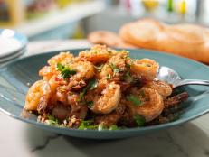 This is one of those classic dishes that doesn't need anything more. It's always about allowing the subtle sweetness and brininess of the shrimp to coexist peacefully with the garlic and oil. You need some butter to balance the olive oil for the taste of the sauce. You also need canola oil for high-heat cooking of the shrimp. Once these ingredients come together, you will understand. Serve this dish with buttered pasta or loaves of seriously crusty bread. I have also been known to go overboard and make buttery garlic bread on the side.